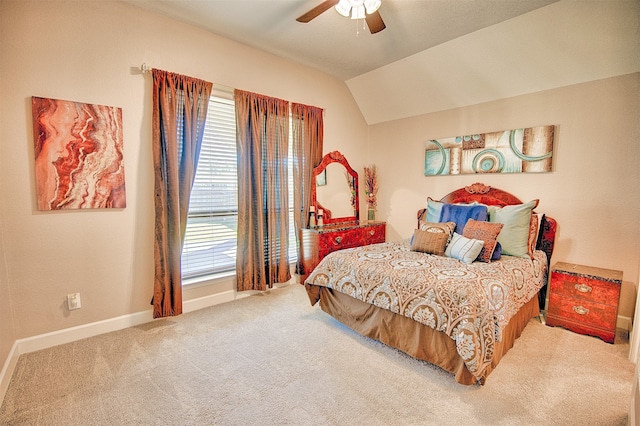 carpeted bedroom with multiple windows, ceiling fan, and lofted ceiling