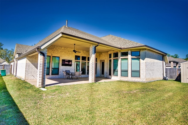 rear view of house featuring a patio, ceiling fan, and a lawn