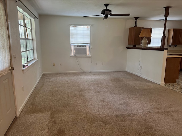 unfurnished living room featuring ceiling fan, cooling unit, and light colored carpet