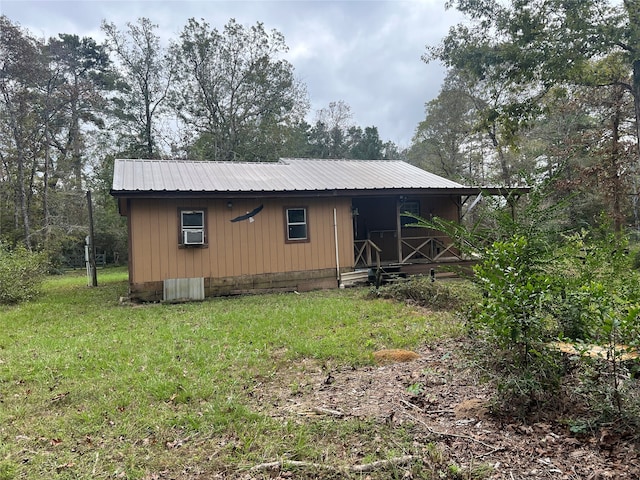 exterior space with cooling unit and a front lawn