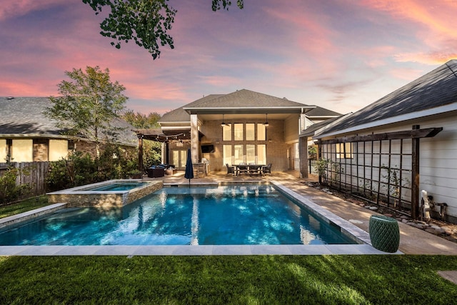 pool at dusk with a patio area, an in ground hot tub, and ceiling fan