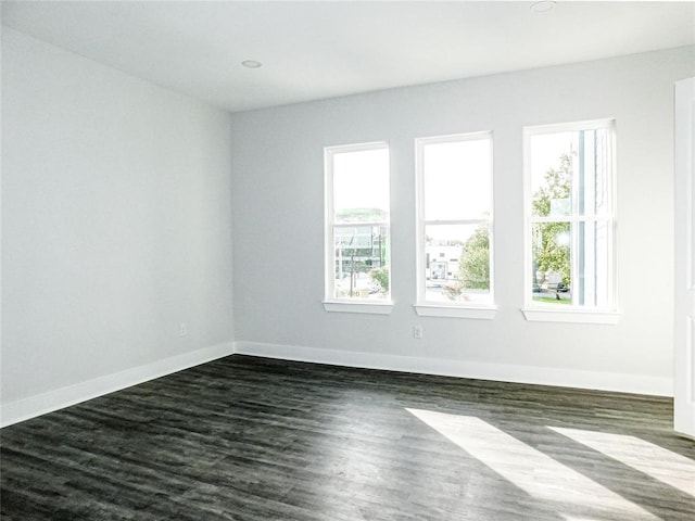 spare room featuring dark wood-type flooring