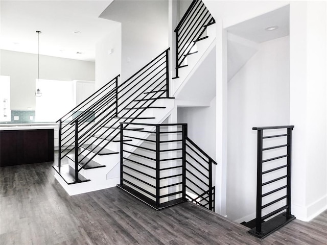 staircase featuring wood-type flooring