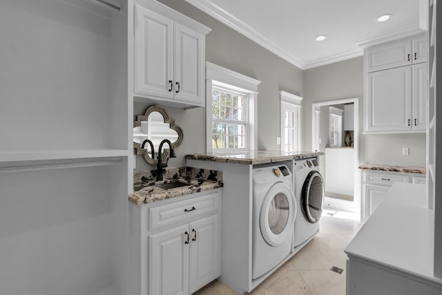 laundry room with sink, cabinets, light tile patterned floors, washer and dryer, and ornamental molding