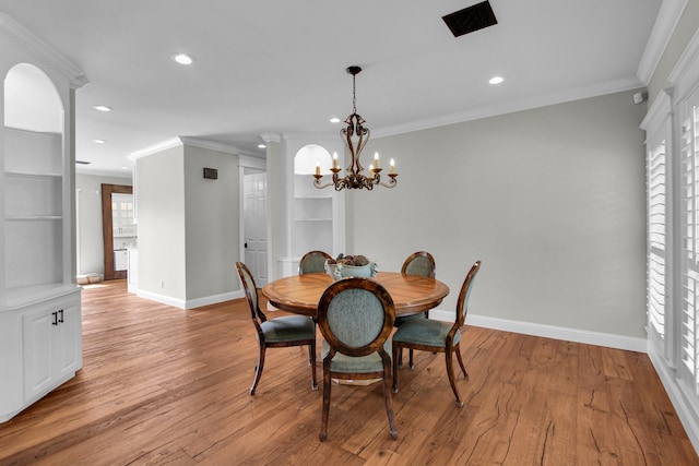 dining room with light wood-type flooring, plenty of natural light, and ornamental molding