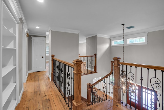 hall with wood-type flooring and crown molding