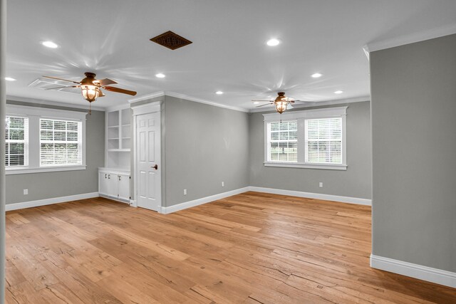 unfurnished room featuring crown molding, ceiling fan, and light wood-type flooring