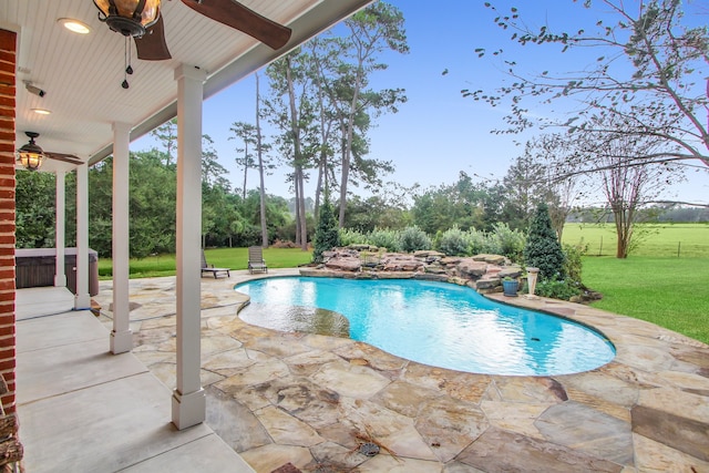 view of swimming pool featuring a patio area, ceiling fan, and a yard