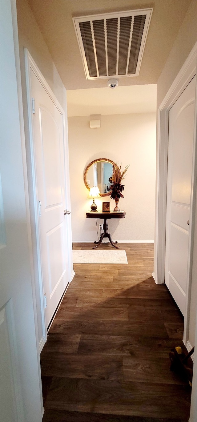 hallway with dark hardwood / wood-style floors