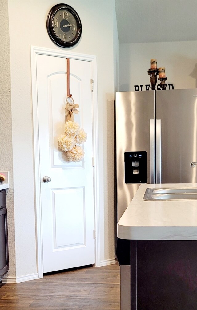 kitchen featuring stainless steel fridge, sink, and light hardwood / wood-style floors