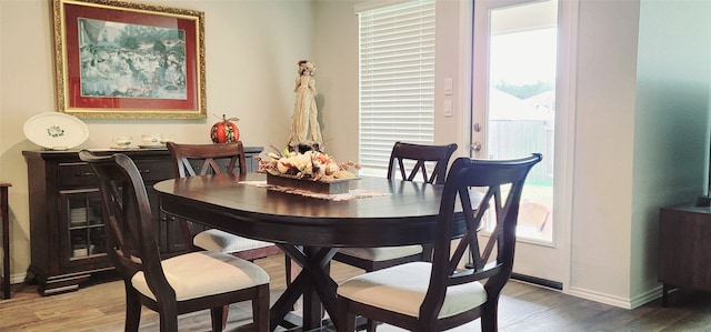 dining space with hardwood / wood-style flooring and a wealth of natural light