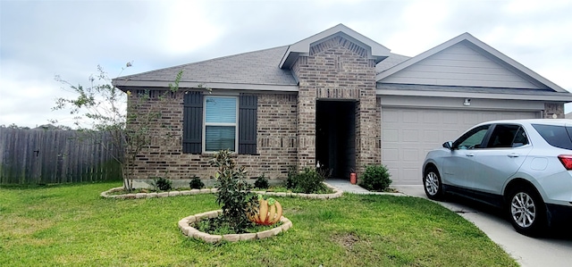 view of front of home featuring a garage and a front yard