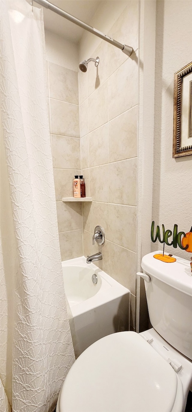 bathroom featuring shower / tub combo with curtain and toilet