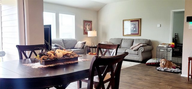 dining area featuring dark hardwood / wood-style flooring and lofted ceiling