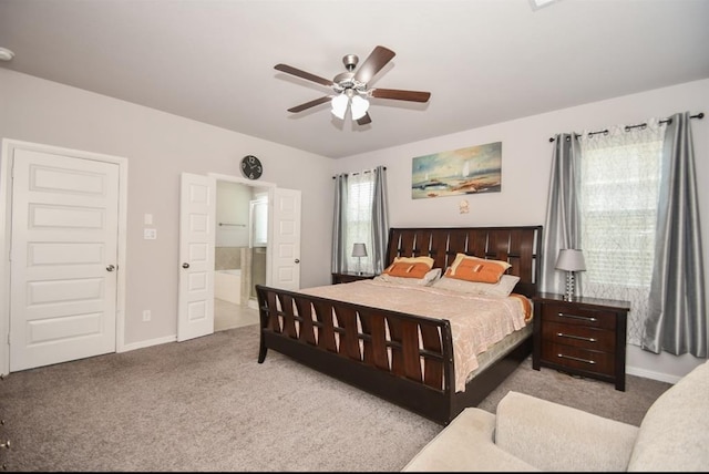 carpeted bedroom with ceiling fan and ensuite bathroom