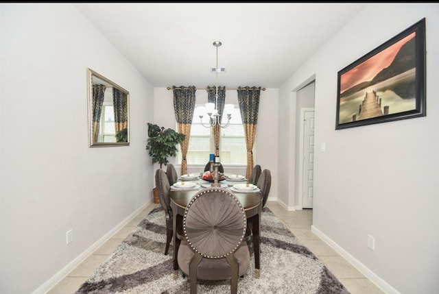 dining space featuring light tile patterned floors and a chandelier