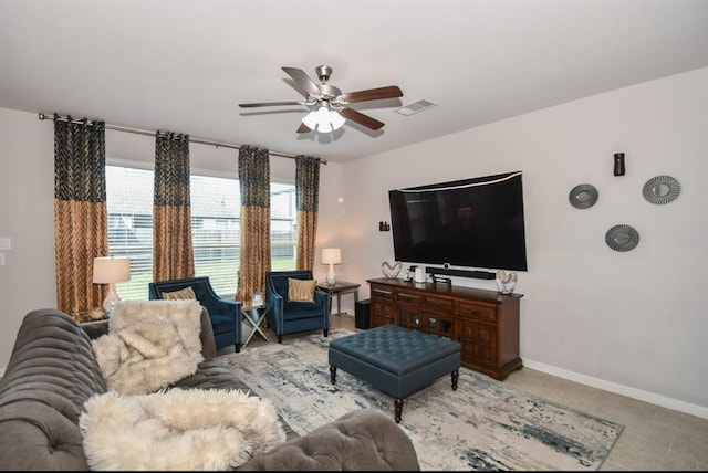 tiled living room with ceiling fan