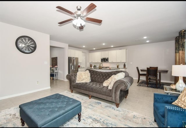 living room featuring light tile patterned floors and ceiling fan