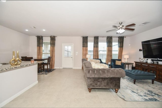 tiled living room with ceiling fan