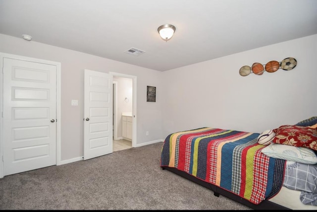 carpeted bedroom with ensuite bath