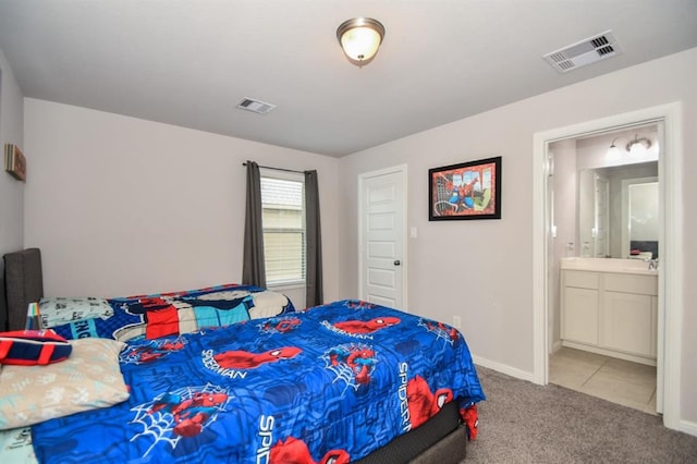 bedroom with carpet flooring, connected bathroom, and sink