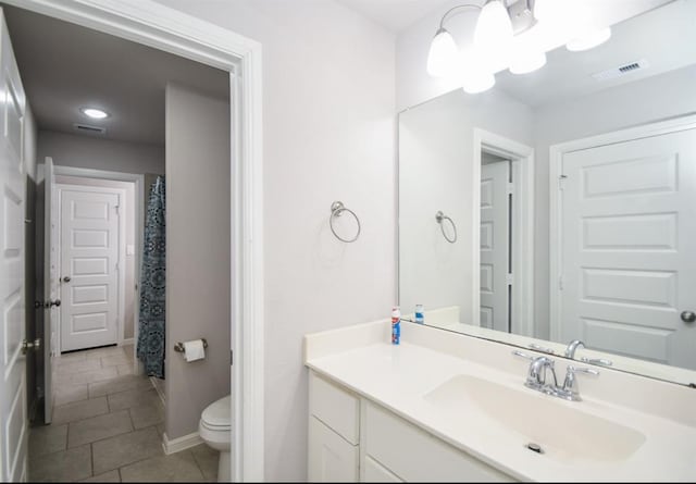 bathroom featuring tile patterned floors, vanity, and toilet