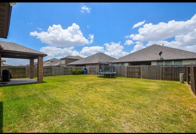 view of yard with a trampoline