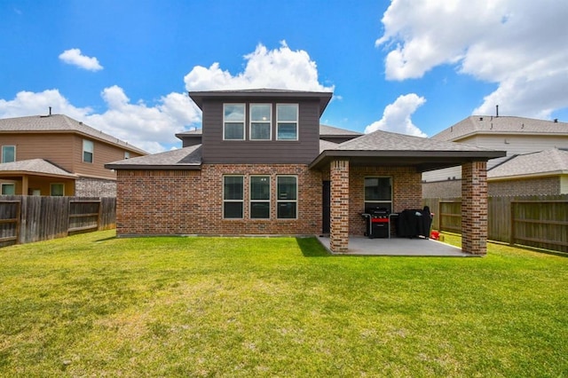 rear view of property with a yard and a patio