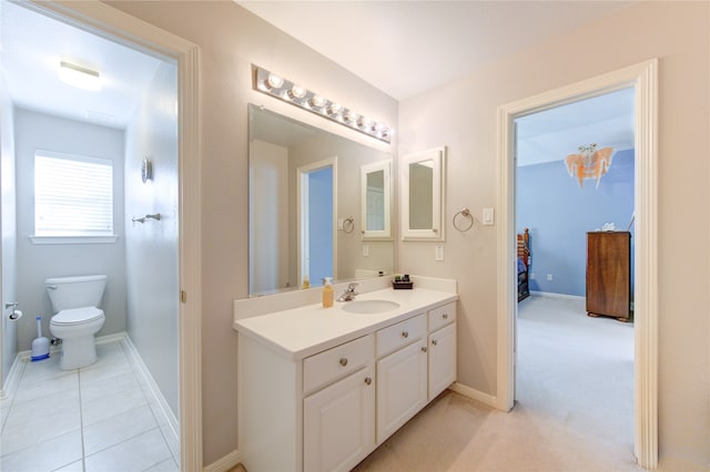 bathroom with tile patterned flooring, vanity, and toilet