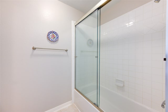 bathroom with bath / shower combo with glass door