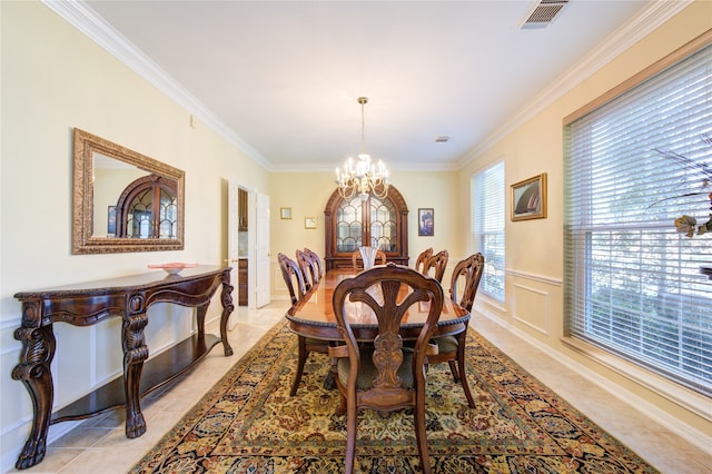 dining room with an inviting chandelier and crown molding