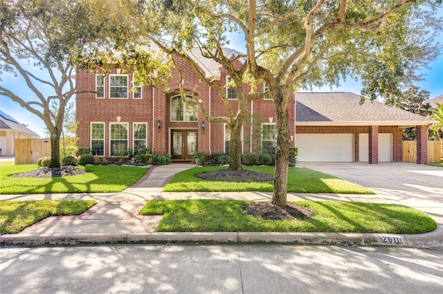 view of front of home featuring a front yard, french doors, and a garage