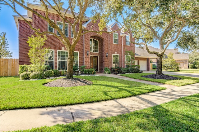 tudor-style house featuring a front lawn