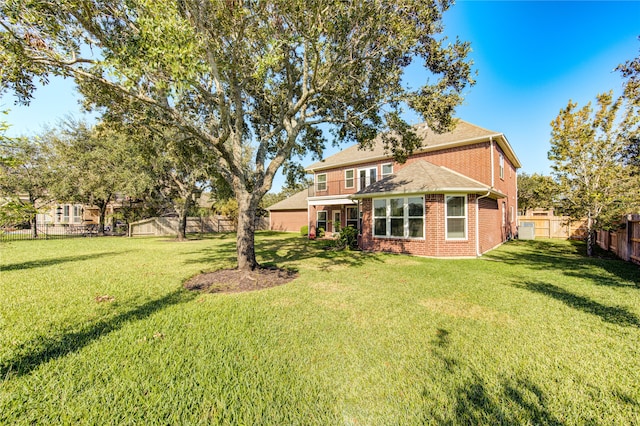 back of house featuring a yard