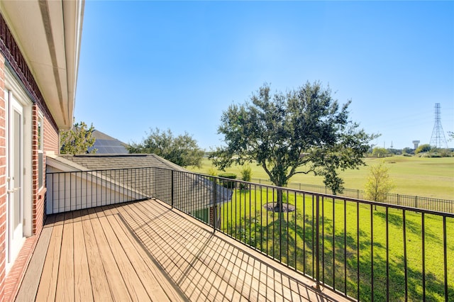 wooden terrace featuring a lawn