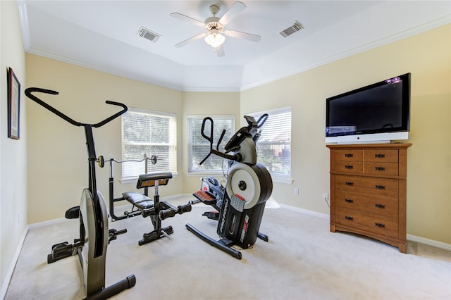 exercise room with light colored carpet, ceiling fan, and crown molding