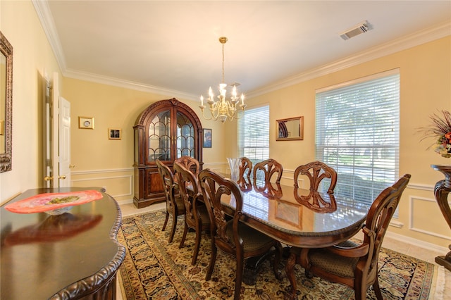 tiled dining space with a notable chandelier and ornamental molding