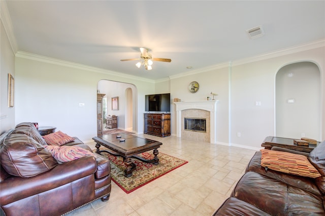 living room with a fireplace, ceiling fan, and crown molding