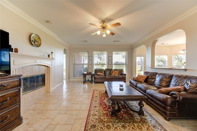 living room with a fireplace, ceiling fan, and crown molding