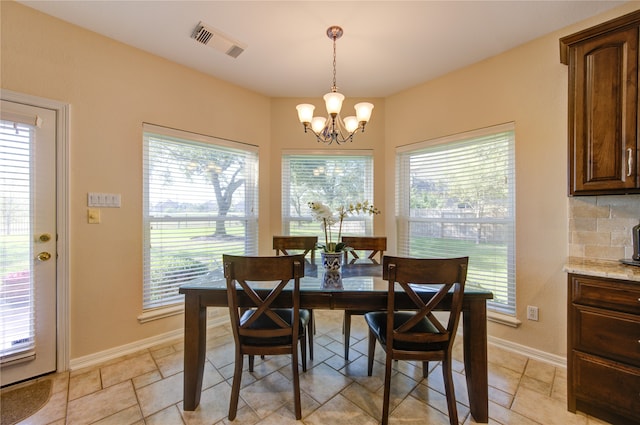 dining space with an inviting chandelier