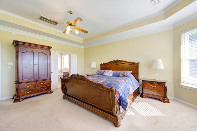 carpeted bedroom with ceiling fan, ornamental molding, and a tray ceiling