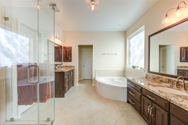 bathroom with shower with separate bathtub, vanity, and tile patterned floors