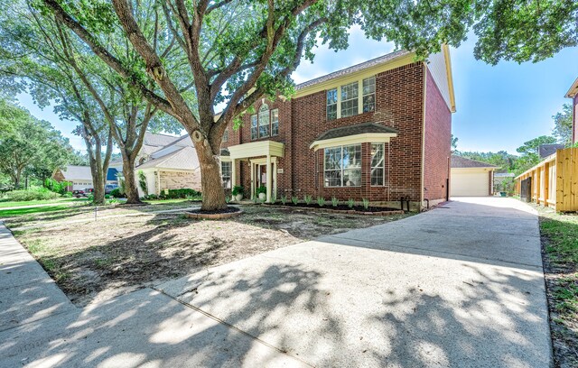 view of front of house with a garage and an outdoor structure