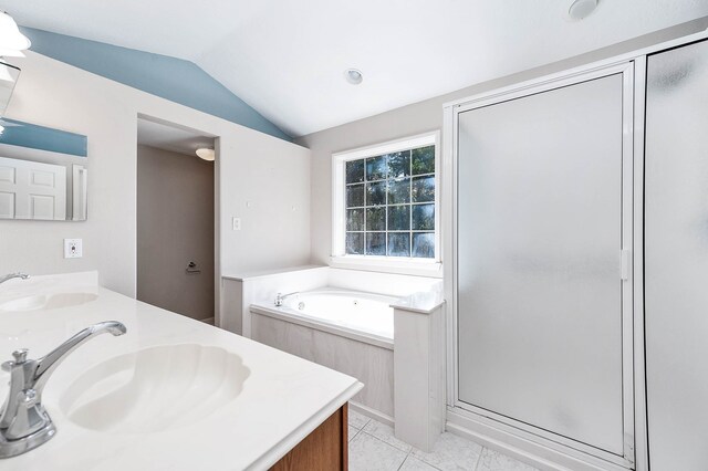 bathroom with tile patterned flooring, vanity, separate shower and tub, and lofted ceiling