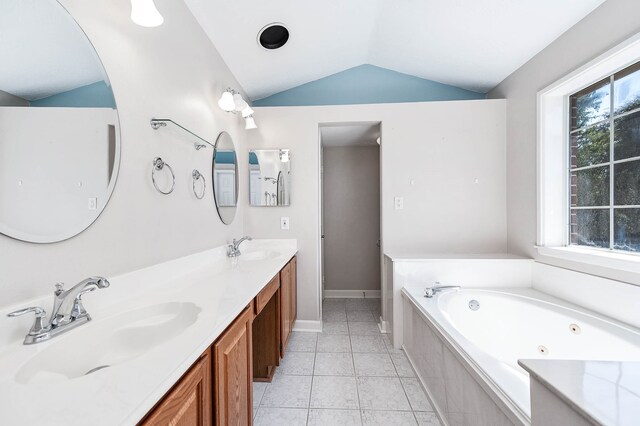 bathroom with tile patterned flooring, a relaxing tiled tub, vaulted ceiling, and a healthy amount of sunlight