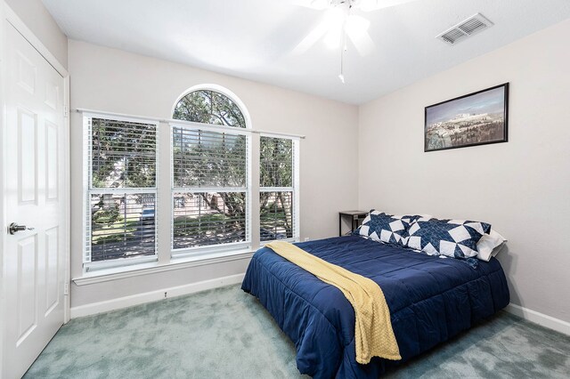 carpeted bedroom with ceiling fan