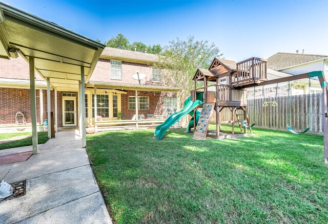 view of jungle gym featuring a lawn and a patio area