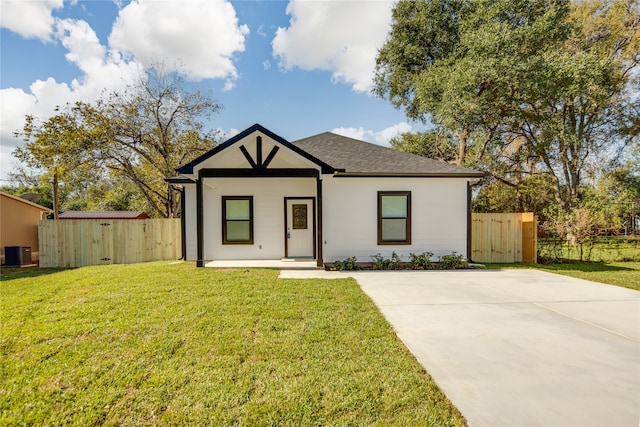 view of front of property featuring cooling unit, covered porch, and a front yard