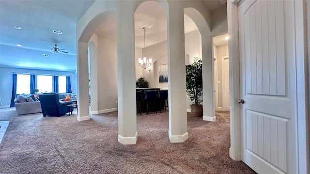 interior space featuring carpet and a chandelier