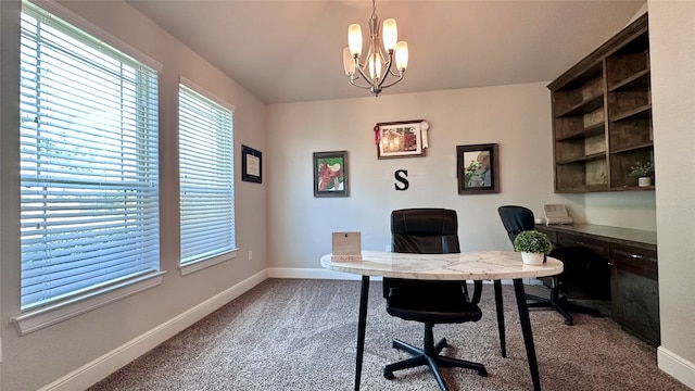 office with carpet floors and a notable chandelier